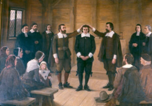 Image of men in Puritan-style dress at an ordination ceremony.